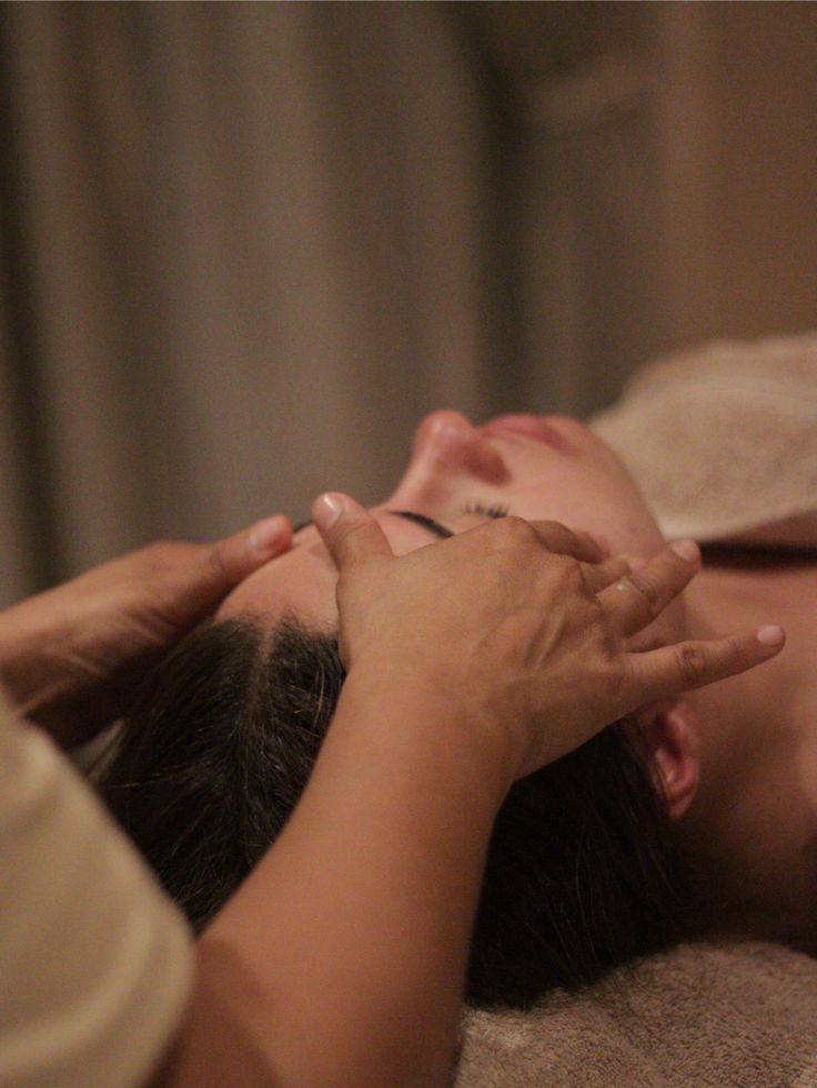 Woman enjoying a relaxing head and shoulder massage at Shweta Beauty Studio in Delhi